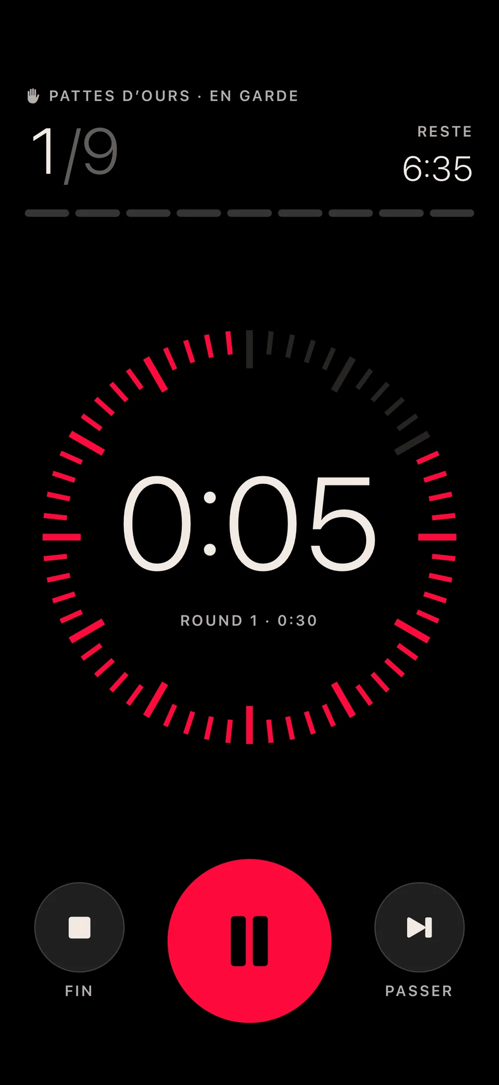 Le timer en cours : round 1 sur 9, 5 secondes restantes, cadran rouge à 60 graduations.